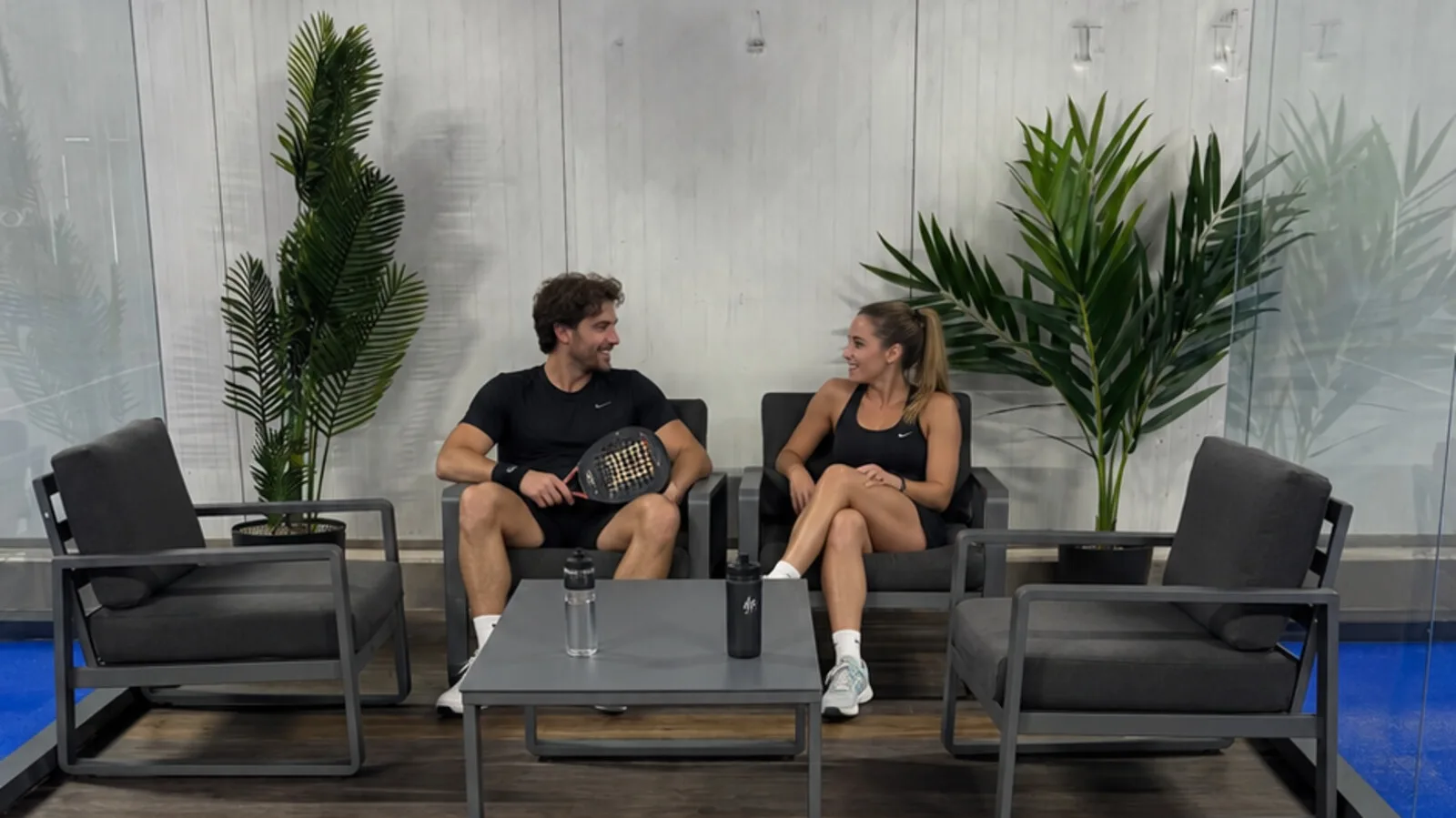 Loungebereich der PDLX-Halle mit Sitzgruppe am Court (Visualisierung: Personen KI-erg&auml;nzt)